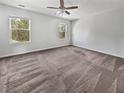 Spacious bedroom with neutral carpet, ample natural light from two windows, and a ceiling fan at 359 Dunlin Dr, Summerville, SC 29486