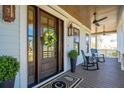 Inviting front door with a decorative wreath, elegant lanterns, and comfortable rocking chairs on the porch at 3858 Sawyers Island Dr, Mount Pleasant, SC 29466