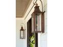 Close-up view of elegant outdoor lanterns and a decorative wreath on the front door at 3858 Sawyers Island Dr, Mount Pleasant, SC 29466