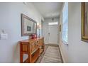 Inviting entryway with wood-look floors, a decorative table, and ample natural light at 430 Eastern Pine Dr, Summerville, SC 29486