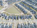 An aerial view of a well-planned residential neighborhood with a lake surrounded by houses and streets at 444 Parish Farm Dr, Summerville, SC 29486
