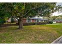 Classic red brick home with mature trees and hedges offers timeless appeal at 5040 Lancaster St, North Charleston, SC 29405