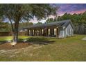 Charming home with a metal roof, welcoming front porch and rocking chairs for enjoying the outdoors at 508 Horse Trail Rd, Saint George, SC 29477