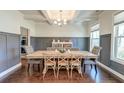Elegant dining room featuring coffered ceilings, modern lighting, panelled walls and hardwood floors at 5525 Alpine Dr, Summerville, SC 29483