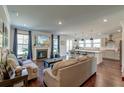 Open concept living room featuring a fireplace, hardwood floors, and seamless flow to kitchen at 5525 Alpine Dr, Summerville, SC 29483
