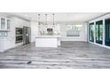 Bright, open kitchen with white cabinets, stainless steel appliances, and a spacious island at 566 Four Seasons Blvd, Summerville, SC 29486
