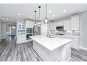Modern kitchen with white cabinetry, stainless steel appliances, and large center island at 566 Four Seasons Blvd, Summerville, SC 29486