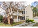 Attractive two-story home with double porches, neutral siding, black shutters, and detached garage at 569 Delafield Dr, Summerville, SC 29483