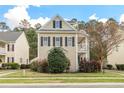 Charming two-story home with neutral siding, black shutters, well-kept lawn and a lovely porch at 569 Delafield Dr, Summerville, SC 29483
