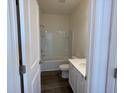 Bright bathroom with a shower-tub combo, modern vanity, toilet, and wood-look flooring at 719 Pisces Ln, Summerville, SC 29486