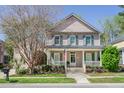 Beautiful two-story home with a cozy front porch, green shutters and mature landscaping at 772 Preservation Pl, Mount Pleasant, SC 29464