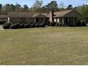 Brick home exterior with mature landscaping and green lawn at 7819 Bells Hwy, Ruffin, SC 29475