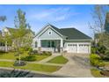 Charming single-story home featuring a welcoming front porch, manicured lawn, and a two-car attached garage at 804 Buckler St, Summerville, SC 29486