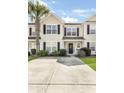 Inviting two-story townhome featuring manicured landscaping and a spacious driveway at 8842 Gable St, North Charleston, SC 29406