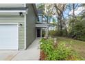 A close-up of the home's front door, with a view of the walkway lined with flowering shrubs at 103 Rosa Gray Ln, Goose Creek, SC 29445