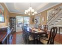 Elegant dining room with a chandelier, large table, and views of the entry and staircase at 1067 Shipton Ct, Charleston, SC 29414