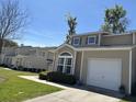 View of townhomes with attached garages and blue sky backdrop at 111 Spanish Oak Ln, Ladson, SC 29456