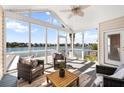A screened porch provides shade to wicker chairs, a wooden table, and expansive views of the lake at 1124 Clearspring Dr, Charleston, SC 29412