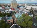 Aerial view of historic townhomes with the Ravenel Bridge and harbor in the background at 12 Elliott St # A, Charleston, SC 29401