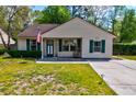 Well-kept single-story home with a tidy front lawn and concrete walkway at 1257 Maryland Dr, Ladson, SC 29456