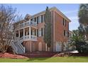 Beautiful brick home with dual front porches, black shutters, a side-entry garage, and well-maintained landscaping at 1369 Tidal Creek Cv, Charleston, SC 29412