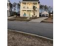 Attractive two-story home with a covered porch, featuring a blue door, an inviting seating area, and a detached garage at 149 Greenbelt Ct, Summerville, SC 29485