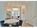 Open kitchen and dining area featuring stainless appliances, island with seating, and decorative lighting at 1510 Cecile St, Mount Pleasant, SC 29464