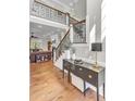 Elegant foyer with high ceilings, wood floors, staircase, and stylish furniture at 1626 Bull Creek Ln, Charleston, SC 29414