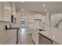 Well-lit kitchen with stainless appliances, quartz countertops, subway tile backsplash, and generous cabinet space at 197 Belfort Pl, Summerville, SC 29486