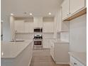 Bright kitchen with white cabinets, stainless steel appliances, and quartz countertops for a modern feel at 197 Belfort Pl, Summerville, SC 29486