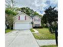 Charming two-story home with a well-maintained lawn, paved driveway, and traditional architectural details at 203 Arbor Oaks Dr, Summerville, SC 29485