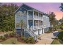 Stunning three-story home featuring a double-balcony and a well-maintained yard at 2322 Dorado Ct, Johns Island, SC 29455