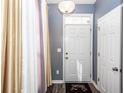 Entryway featuring wood floors and a stylish door with a 'Blessed' welcome mat at 2431 Thoreau Ln, Charleston, SC 29406