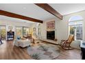Cozy living room with wood beams, a tile fireplace, and a sun-filled window at 3005 Ocean Winds Dr, Seabrook Island, SC 29455
