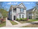 Charming two-story home with a cozy front porch and beautifully landscaped front yard at 3020 Plumier Pl, Charleston, SC 29414