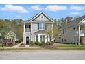 Charming two-story home with a cozy front porch and beautifully landscaped front yard at 3020 Plumier Pl, Charleston, SC 29414