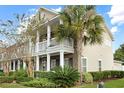 Two-story townhome with brick, siding, lush landscaping, and a welcoming covered porch at 3025 Lazarette Ln, Charleston, SC 29414