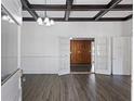 Spacious living room with coffered ceilings, white walls, beautiful wood floors, and french doors at 311 Black St, Walterboro, SC 29488