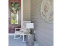 Inviting covered front porch with rocking chair and stylish decor at 345 Turnstone St, Mount Pleasant, SC 29464