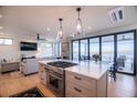 Open-concept kitchen with a large island, stainless steel appliances, and seamless flow to the living area at 3803 B Scott Creek Dr, Edisto Beach, SC 29438