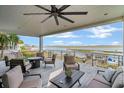 Outdoor deck with comfortable seating, a ceiling fan, and scenic water views, perfect for entertaining and relaxation at 3803 B Scott Creek Dr, Edisto Beach, SC 29438