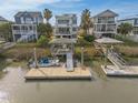 Waterfront home featuring a private dock, boat lift, and direct access to the waterway for boating and recreation at 3803 B Scott Creek Dr, Edisto Beach, SC 29438