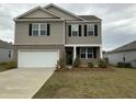 Charming two-story home with a two-car garage, neutral siding, and a well-manicured front lawn on an overcast day at 413 Cedarview Rd, Summerville, SC 29486