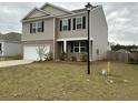 Charming two-story home with a two-car garage, neutral siding, and a well-manicured front lawn on an overcast day at 413 Cedarview Rd, Summerville, SC 29486