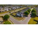 Aerial view of a two-story home with solar panels in a neighborhood with fenced yards and mature trees at 4818 Pitkin Ave, Ladson, SC 29456