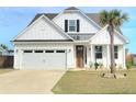 Beautiful exterior showcasing a well-manicured lawn, two car garage and charming architectural details at 609 Sienna Way, Summerville, SC 29486