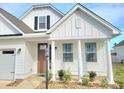 Lovely home showcasing a modern design with covered porch and lush landscaping at 609 Sienna Way, Summerville, SC 29486