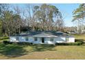 Quaint single-story home featuring a white exterior, simple landscaping, and a cozy front porch area at 6156 Badham Dr, Reevesville, SC 29471