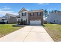 Charming two-story home with brick and siding, offering a well-manicured lawn and inviting curb appeal at 686 Redbud Ln, Summerville, SC 29486