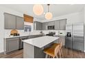 Modern kitchen featuring grey cabinetry, stainless steel appliances, and a bright white quartz countertop island at 739 Meadowbrook Ln, Summerville, SC 29486